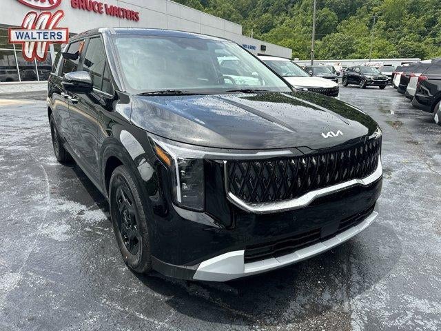 2026 Kia Carnival LXS FWD in Aurora Black Pearl — front three-quarter view